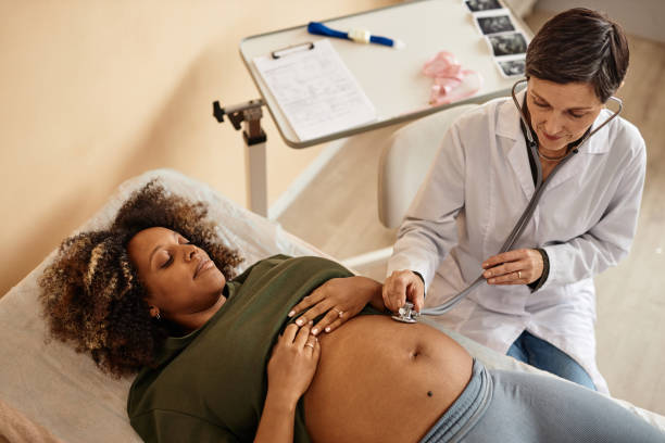 istock Nurse with Expectant Mother Using Stethoscope Checking Fetus 1965472224