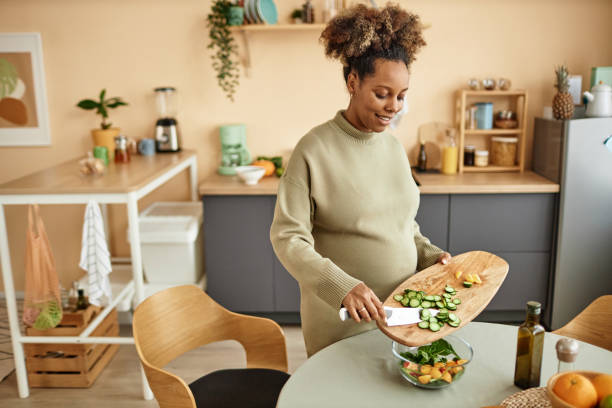 Smiling Pregnant Woman in Kitchen