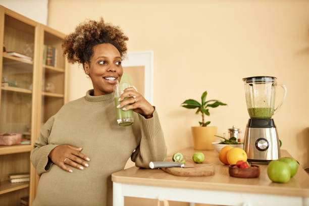 Happy Pregnant Woman with Glass of Smoothie