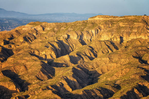 The breathtaking landscape of Granada Geopark showcases vast eroded canyons under a sweeping sky