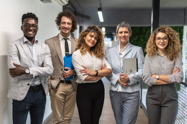 istock A group of successful multiethnic business team at work looking at camera 1965515724