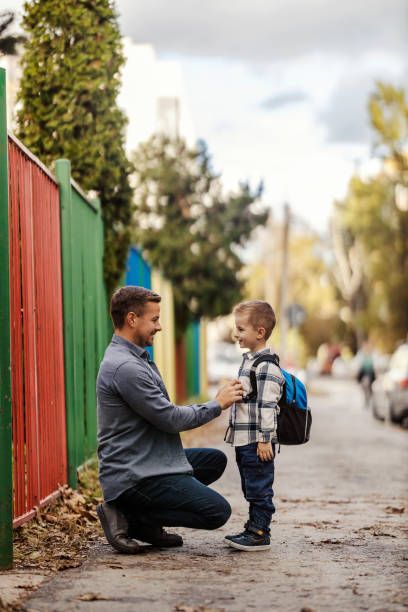 istock A father is buttoning up his son on their way to kindergarten. 1965518932