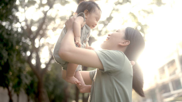 istock mum playing baby in park 1965637885