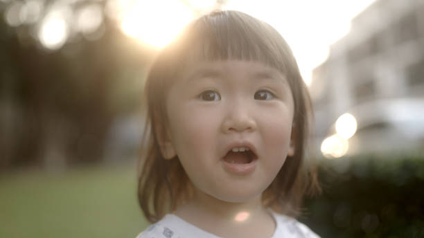 istock Asian girl laughing happily in a park 1965638404