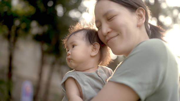 istock mum playing baby in park 1965638413