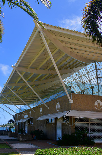 Nouméa, South Province, New Caledonia: building of the 'Gare Maritime', the Martime Terminal, serving both local ferries and visiting cruise ships - large suspend roof providing shade - Jules Ferry Street.