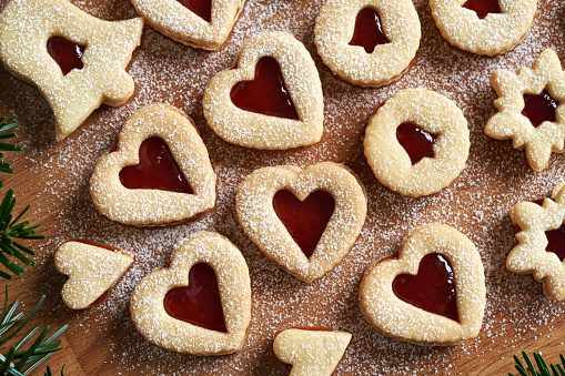 Homemade Linzer Christmas cookies in the shape of hearts with red marmalade