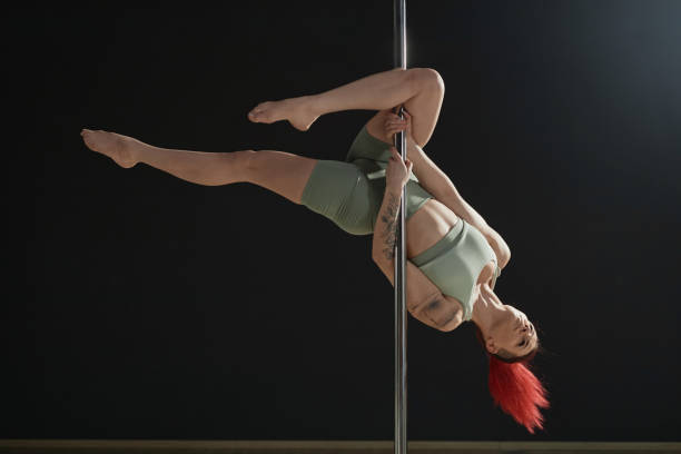 istock Female Dancer Doing Outside Leg Hang on Pole 1965671620