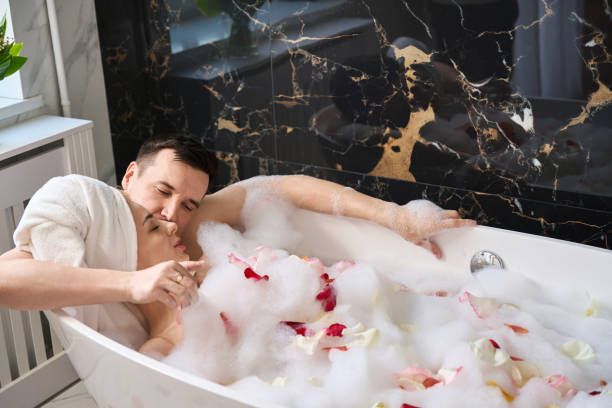 istock Newlyweds soak in a foam bath with rose petals 1965683914