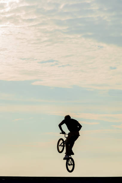 Blurred image of a cyclist on a bike doing a wheelie