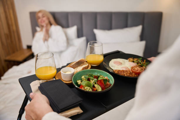 istock Caring husband brings a breakfast tray to bed 1965696156