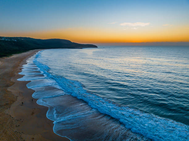 istock Pretty blue sunrise at the beach with calm seas 1965707284