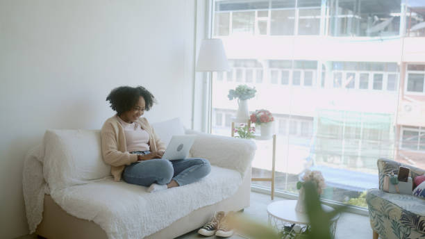 istock woman playing laptop at home 1965708930