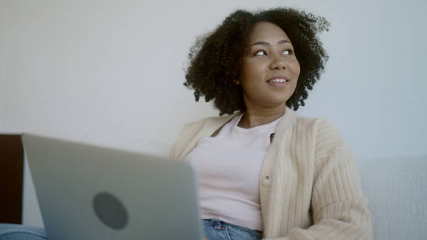 istock woman playing laptop at home 1965709454