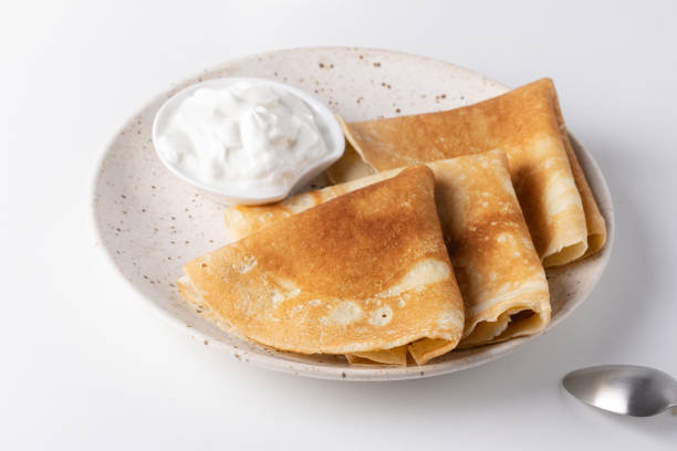 istock Stack of russian thin pancakes blini with fresh sour cream 1965805308