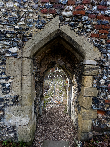 Ancient stone archway door with open white door