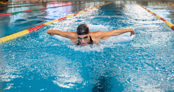 istock Front view of a female swimmer performing butterfly technique 1965840435