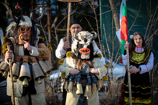 Pernik, Bulgaria - January 26, 2024: 30th anniversary Masquerade festival in Pernik Bulgaria. People with a mask called Kukeri dance and perform to scare the evil spirits.