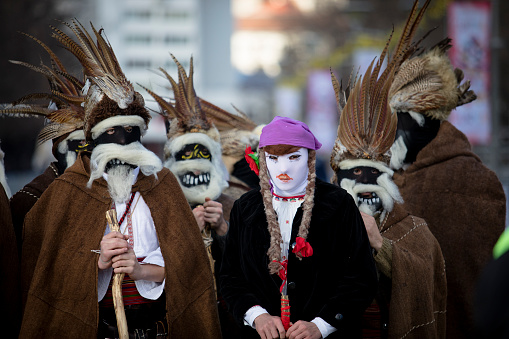 Pernik, Bulgaria - January 26, 2024: 30th anniversary Masquerade festival in Pernik Bulgaria. People with a mask called Kukeri dance and perform to scare the evil spirits.