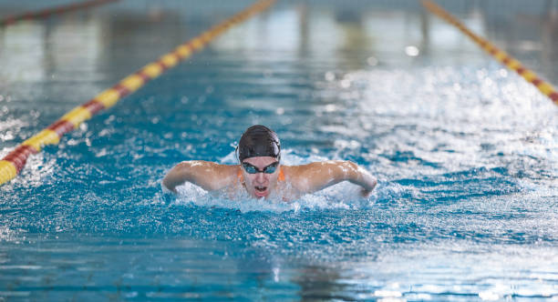 istock Female swimmer moving through the water performs a butterfly stroke 1965844624