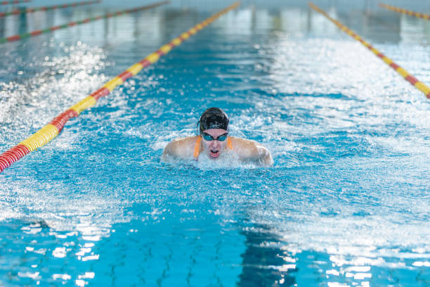 istock Female swimmer moving through the water performs a butterfly stroke 1965855622