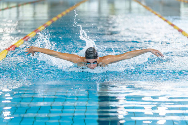 istock Front view of a female swimmer performing butterfly technique 1965864619