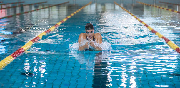 swimmer using breaststroke drills during a swim training session - breaststroke stock-fotos und bilder