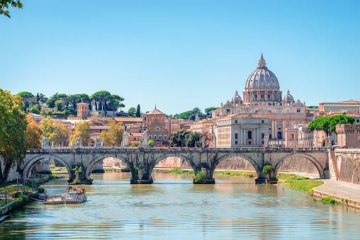 St. Peter's Basilica in Vatican and Tiber river in Rome at sunny day