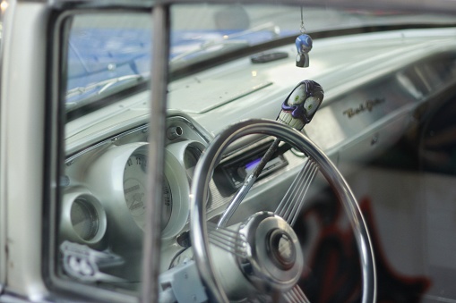 Yogyakarta, Indonesia, June 24, 2012. Variation lever with cartoon figure near the steering wheel on a vintage car.