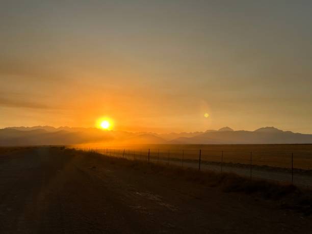 istock Golden sunrise over farmlands 1965928111