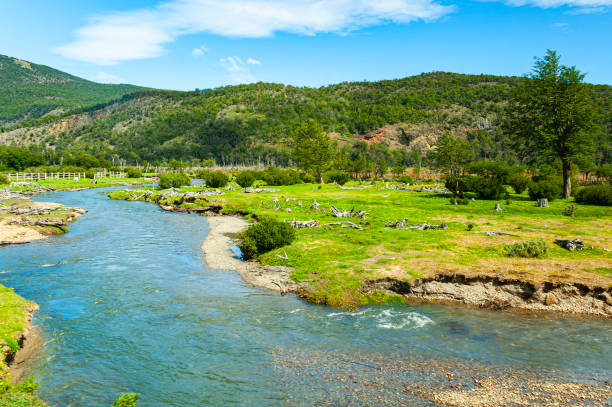 View of the remote landscape dotted with rivers, waterfalls, forest and mountains at the Tierra del Fuego National Park, Argentina’s only coastal national park, as seen from the heritage End of the World train. The rail line follows the route of the original convict train that ran in Ushuaia from 1910 to 1947.