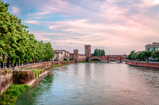 Verona, Italy - May 24 2018:  Panorama of the Adige river with the Castelvecchio Palace and the Castelvecchio Bridge in the background