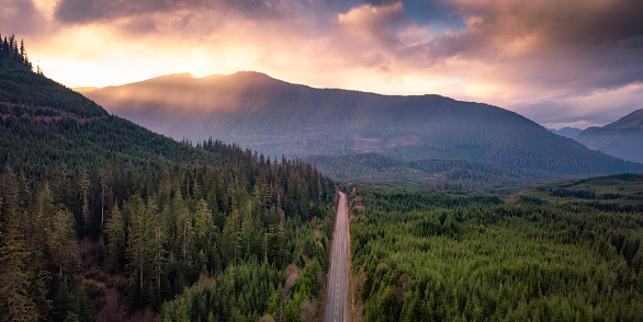 Scenic Road in Vancouver Island, BC, Canada. Aerial View with mountains and fog. Sunset.