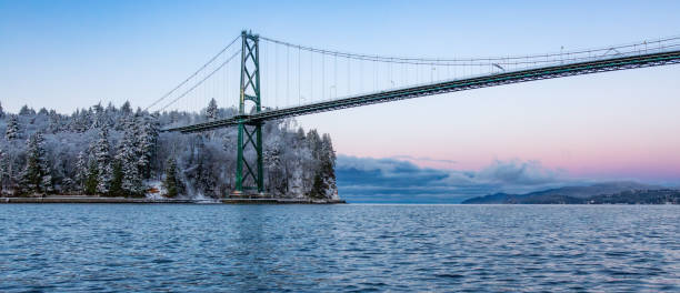 istock Lions Gate Bridge in Stanley Park, Downtown Vancouver. Snow Covered Winter Sunrise 1966002079