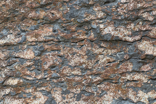 Old stone dark brown wall, textured background