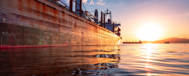 Old rusty ship in the Port during a vibrant sunset. Vancouver, British Columbia, Canada
