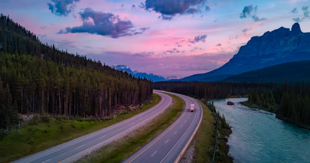 istock Trans-Canada Highway in Canadian Rockies. Sunrise Sky. Alberta, Canada 1966011372