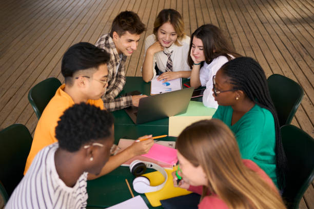 istock Selective focus on a smiling male young university student using laptop in the classroom 1966012351