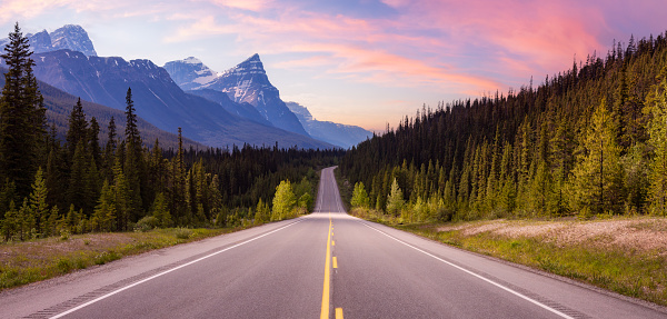 Scenic road in the Canadian Rockies. Colorful Sunset Sky Art Render. Icefields Parkway, Banff National Park, Alberta, Canada. Nature Panorama Background