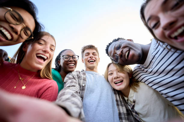 istock Portrait large group multiracial friends posing smiling and looking to camera. Happy young people 1966017068