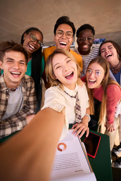 istock A large group of smiling and cheerful young multiracial university students taking a selfie 1966018631