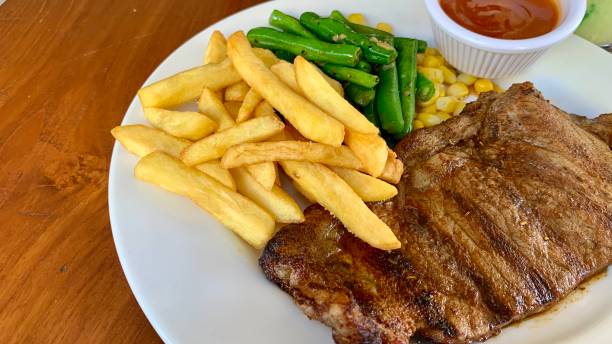 istock Tenderloin steak and vegetables with barbeque sauce 1966092338