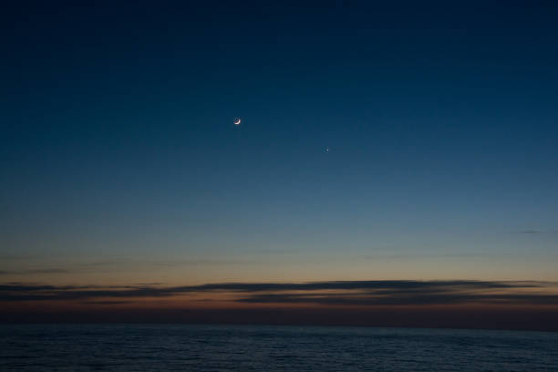 istock Crescent and Venus in the beautiful sea dusk sky 1966094414