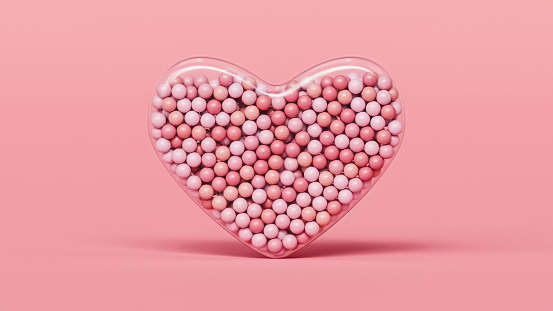 Heart shaped glass filled with pink spheres or balls, Valentine's day abstract background, 3d render