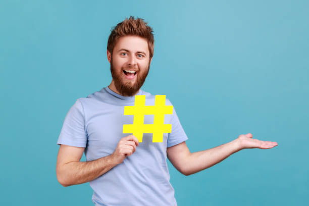 istock Man holding hashtag and presenting at copy space on her palm, empty place for idea presentation. 1966116693