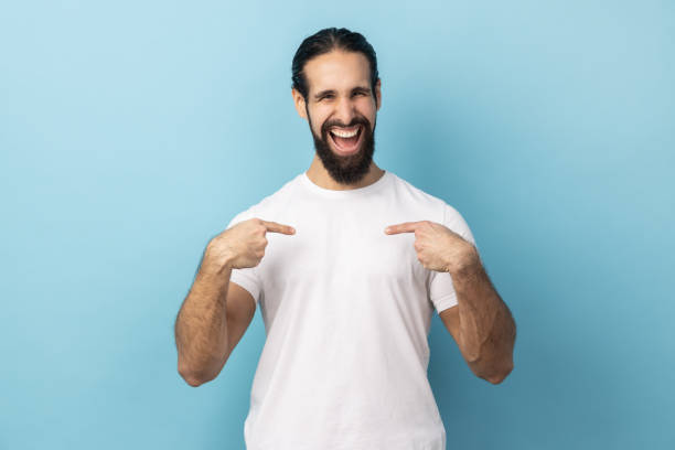 istock Man pointing fingers on himself and looking at camera with toothy smile, extremely satisfied. 1966117720