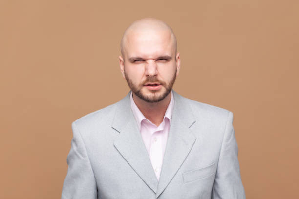 istock Man looks grumpy, feels offended and displease, clenched teeth, looking at camera, wearing jacket. 1966120367