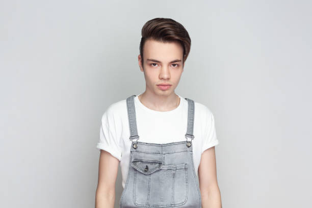istock Strict confident young brunette man standing has serious expression as listens to interlocutor. 1966120894