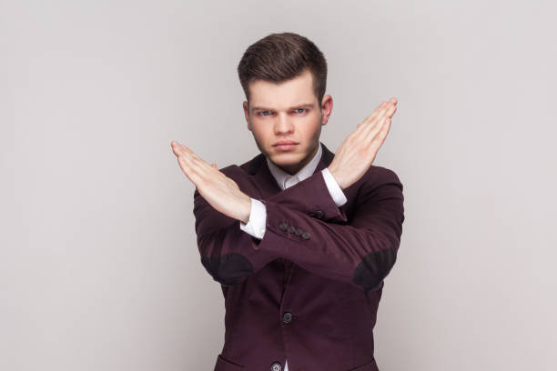 istock No way, absolutely not. Man showing x sign with crossed hands, meaning stop, this is the end. 1966124101