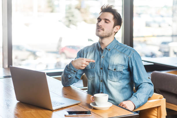 istock Proud egoistic bearded young man freelancer working on laptop, pointing at himself, looks selfish. 1966124648